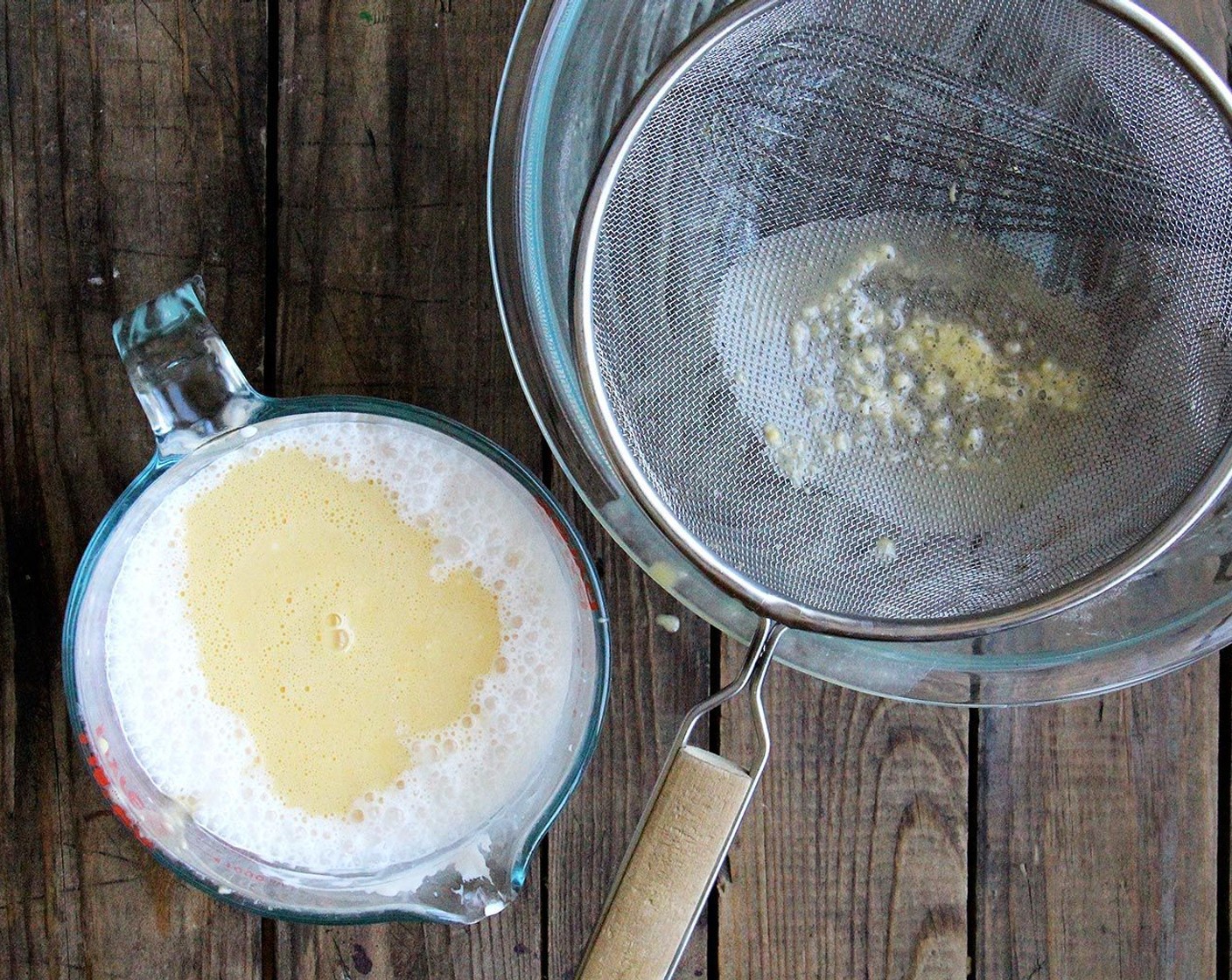 step 8 In a medium bowl, whisk the Crème Fraîche (1 cup) until smooth. Whisk in the Whole Milk (1 cup). Pour the egg mixture through a fine mesh sieve held over the milk mixture.