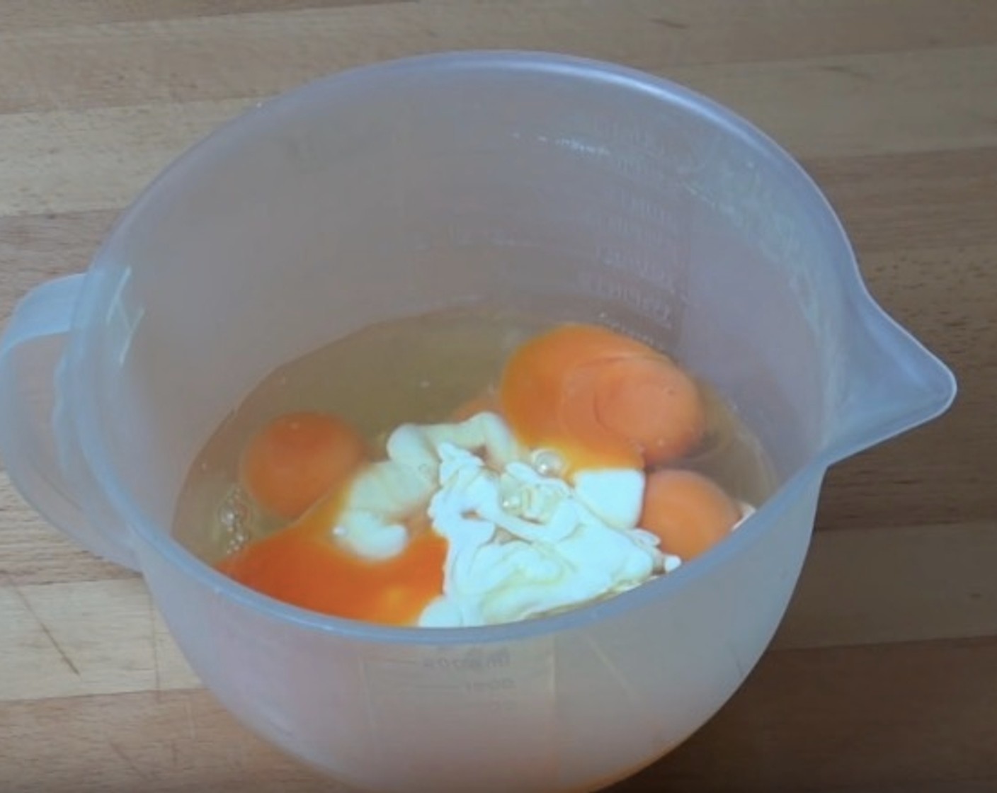 step 8 In a mixing jug, add Eggs (8) and Cream (1/2 cup). Season with Freshly Ground Black Pepper (to taste). Mix together until smooth.