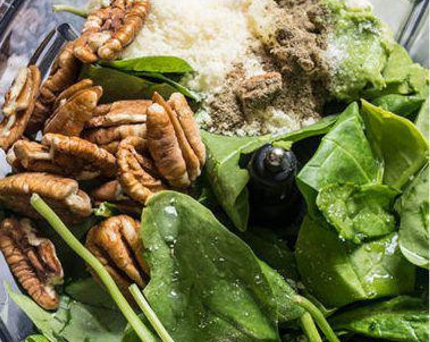 step 2 To make the spinach pesto, add Fresh Spinach (2 cups), Avocado (3/4), Pecans (1/4 cup), Grated Parmesan Cheese (1/4 cup), Garlic (1 clove), juice from Lemon (1), Sea Salt (1/2 tsp), Ground Black Pepper (1/4 tsp), and Water (1 Tbsp) to the food processor.