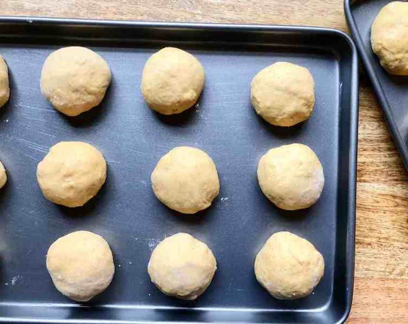 step 8 Shape the dough into 24 balls. Arrange in prepared pans. Cover and let rise in a warm place until nearly double in size (45 to 60 minutes).