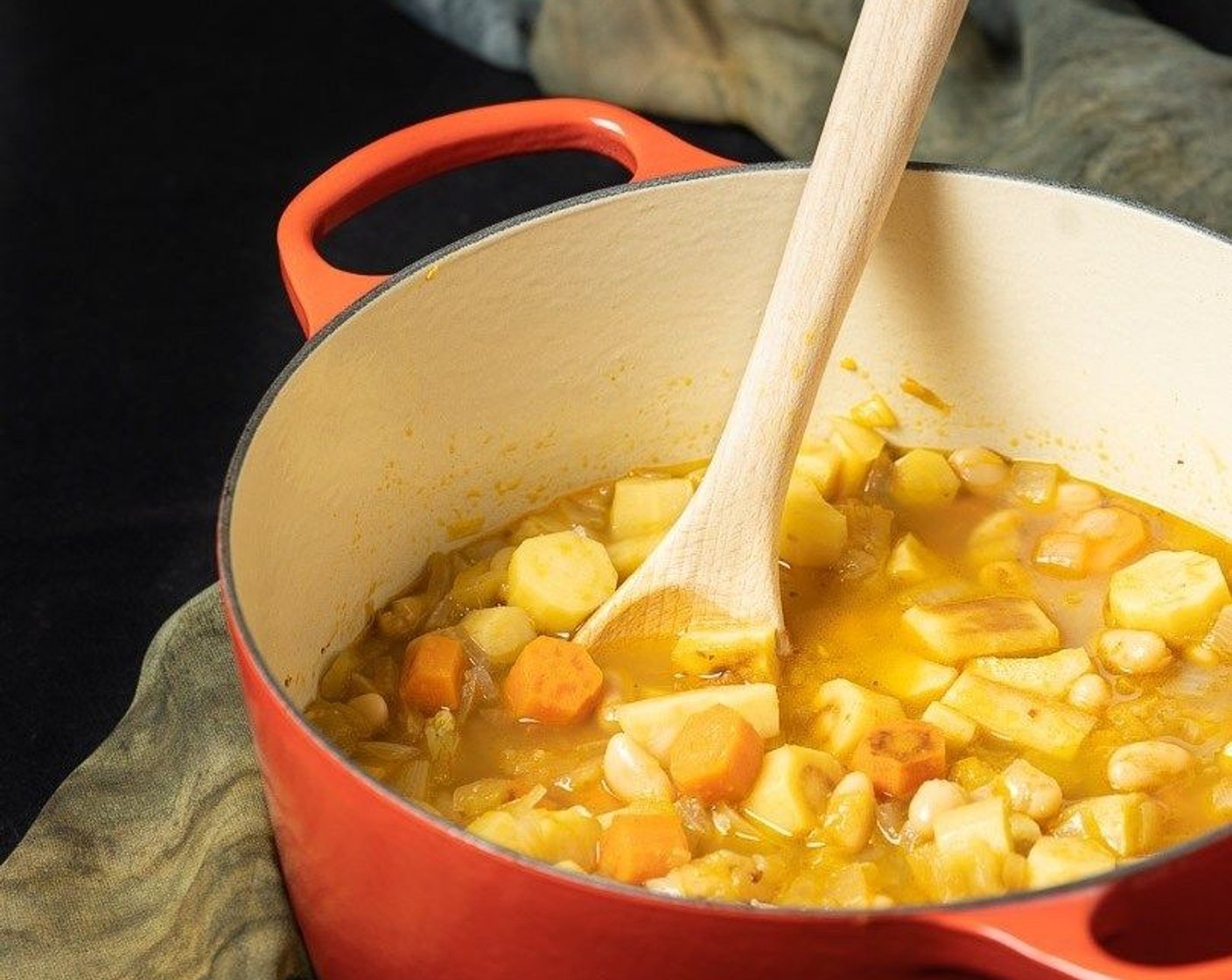 step 4 To the pot add the roasted vegetables, Chicken Broth (4 cups), Cannellini White Kidney Beans (1 can), Red Curry Paste (3 Tbsp), Fresh Ginger (2 tsp), and Kosher Salt (1/2 tsp). Bring to a simmer, cover and cook on low for 30-40 minutes until everything is good and soft.