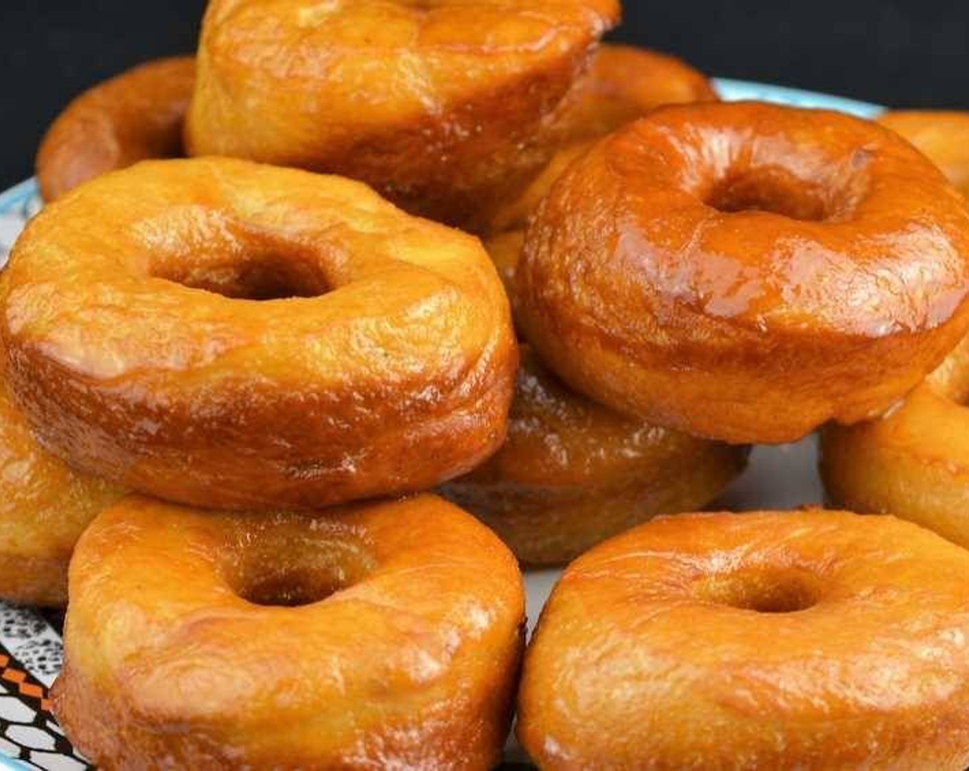 step 10 As they are done, remove the donuts and place them on a plate lined with paper towels to absorb the excess oil and drizzle the glaze on top.