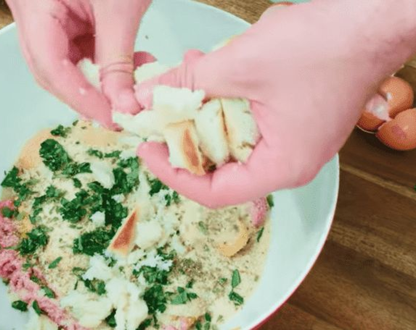 step 9 Break up the wet bread into pieces, using both of your hands, adding them to your main mixture as you go.