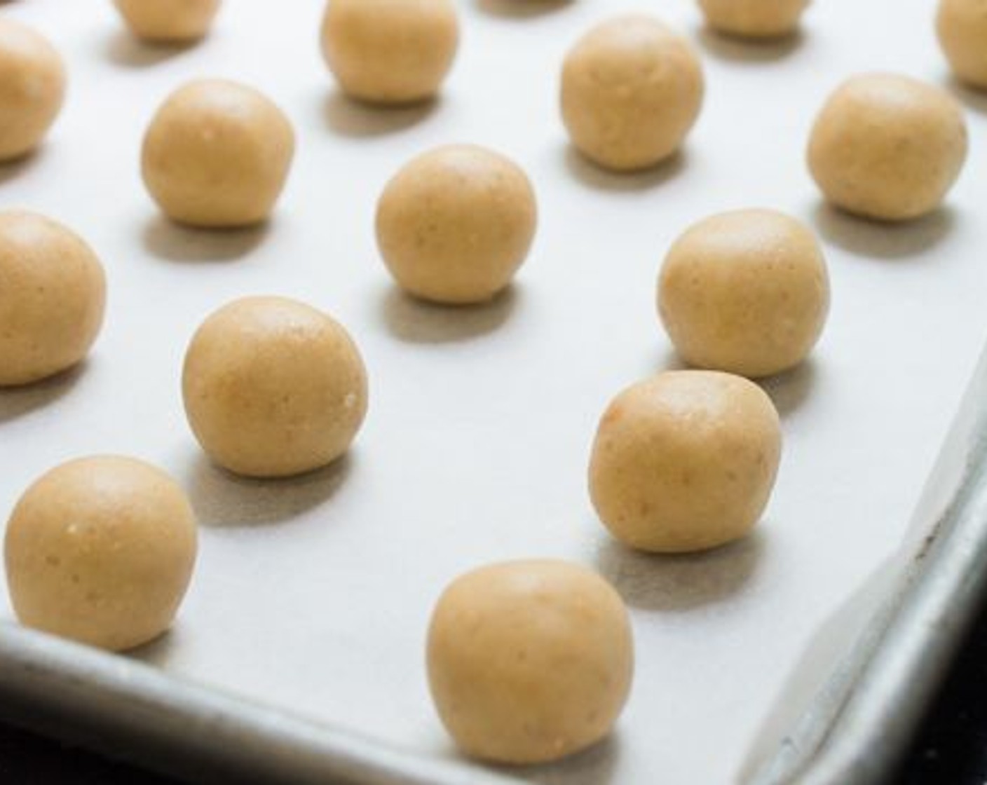 step 6 Arrange the cookie dough balls about an inch apart on a cookie sheet.