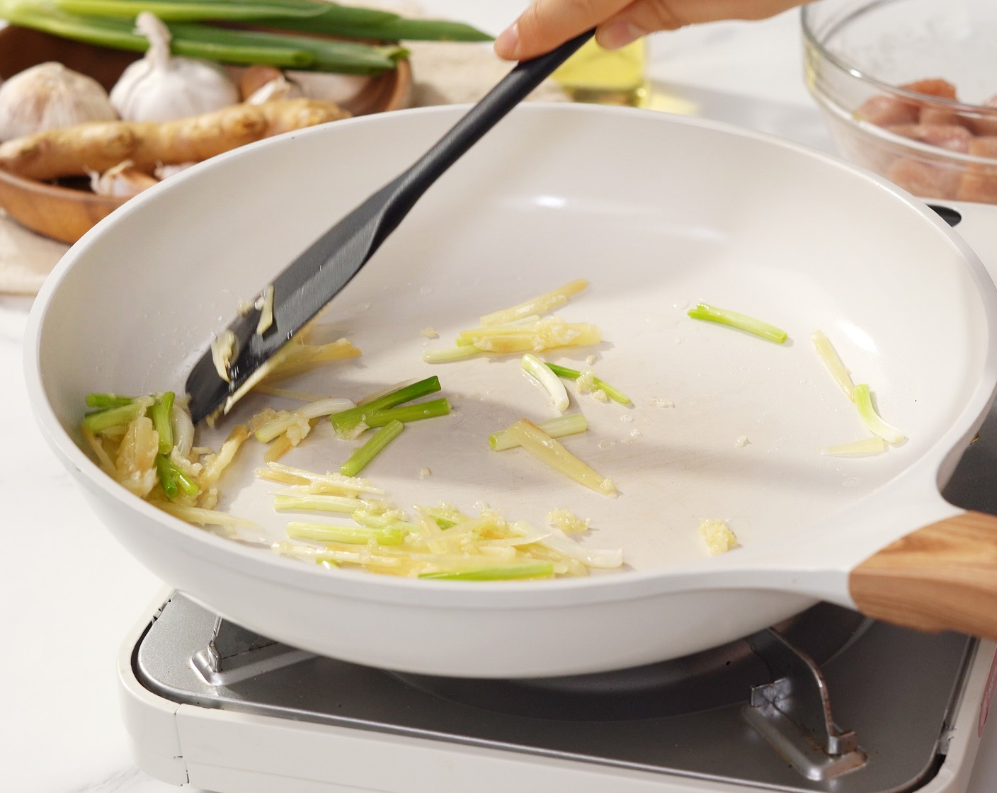 step 4 Heat the Cooking Oil (2 Tbsp) in the pan over medium heat, and add Fresh Ginger (1 piece), Garlic (2 cloves), and the white part of the Scallions (3 stalks). Stir until fragrant about 2 minutes.