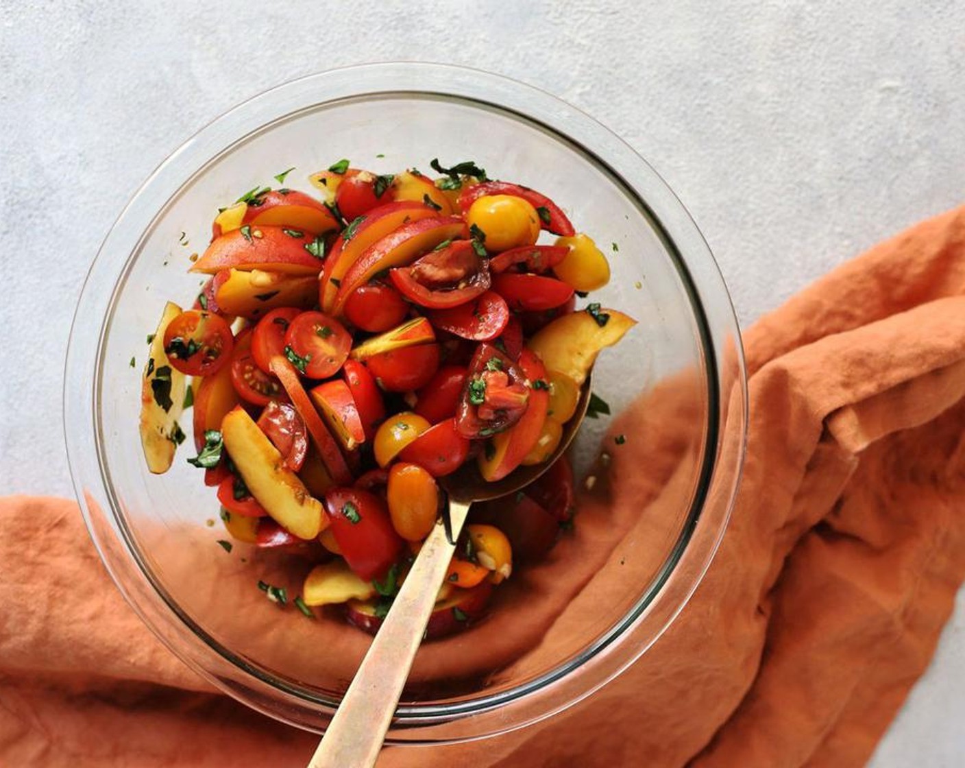 step 1 Chop or slice Peaches (2) and Heirloom Tomatoes (2 1/2 cups) to your preferred sizes and place in a medium bowl with the Fresh Basil (1/3 cup), Fresh Oregano (2 Tbsp), Elephant Garlic (1 Tbsp), Extra-Virgin Olive Oil (2 Tbsp), Balsamic Glaze (1 Tbsp), and Salt (1 tsp). Toss. Set aside and leave to macerate for about 10 minutes.