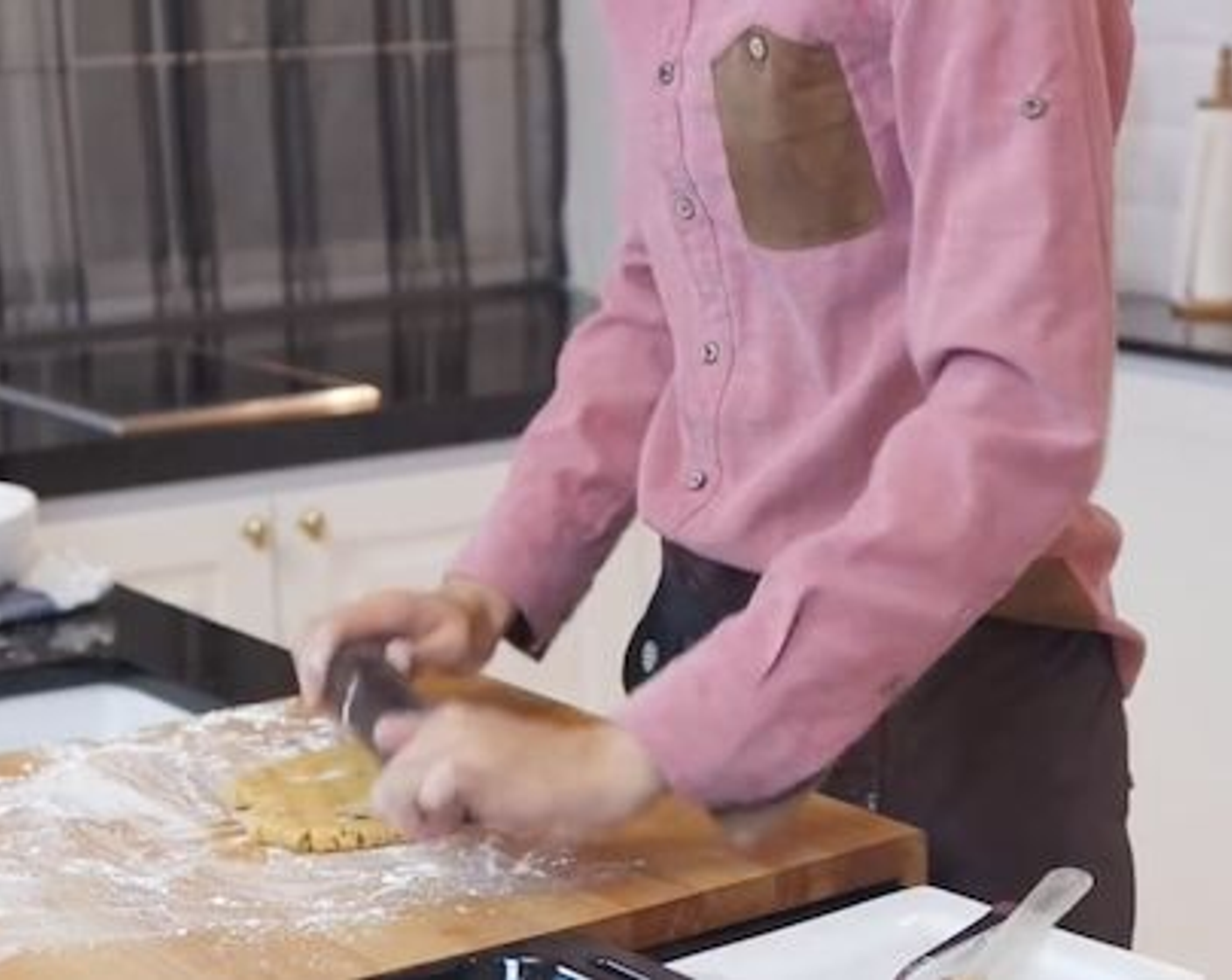 step 5 Roll the dough out on a dusted surface to about 0.5 cm thickness. Then, dust cookie cutter and cut the shape out. Transfer cut out dough onto a baking tray lined with parchment paper. Repeat until all of the dough is used up.