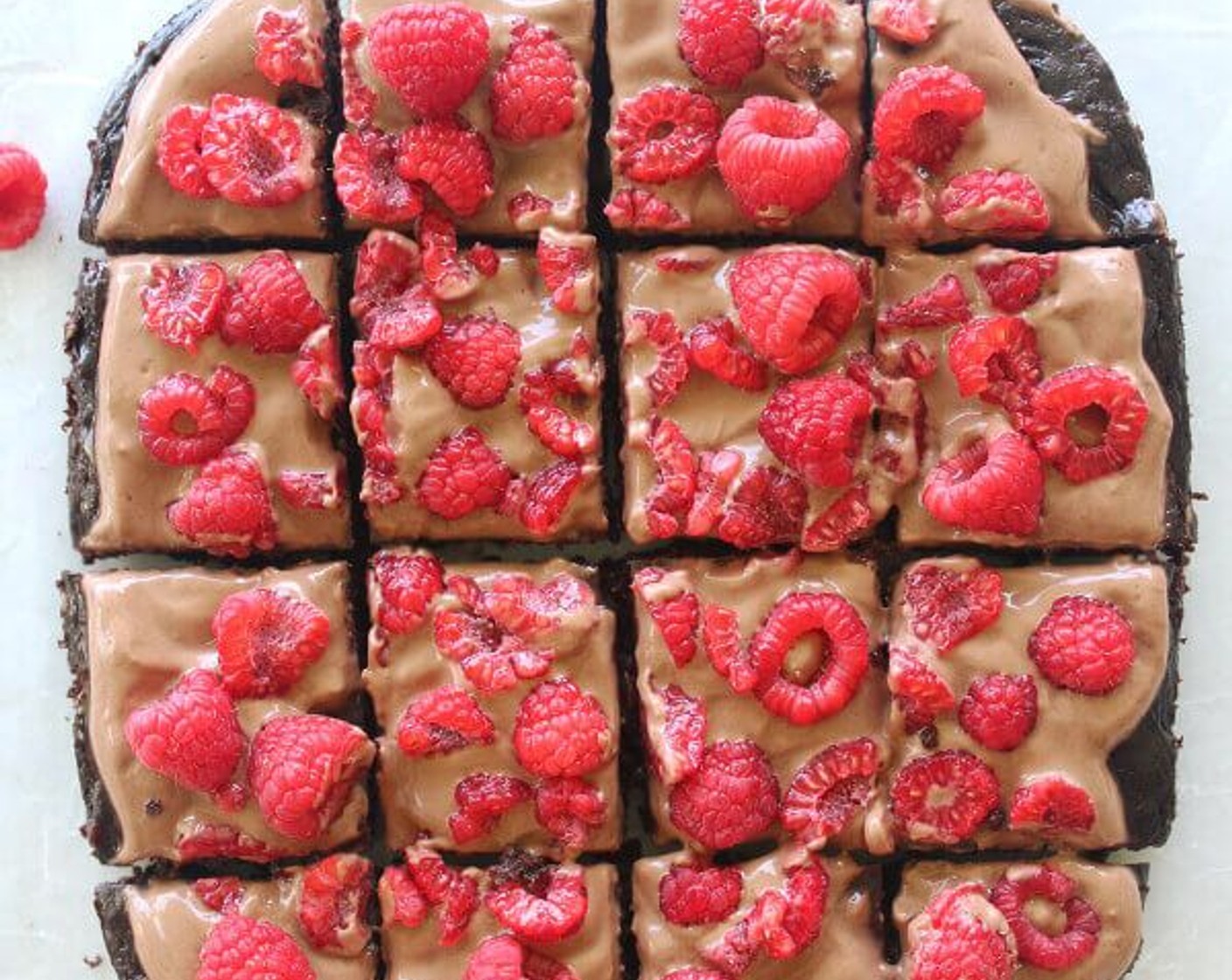 step 6 When the brownies have cooled completely, spoon on the frosting and spread almost to the edges. Top with Fresh Raspberry (1 cup), slice and serve.