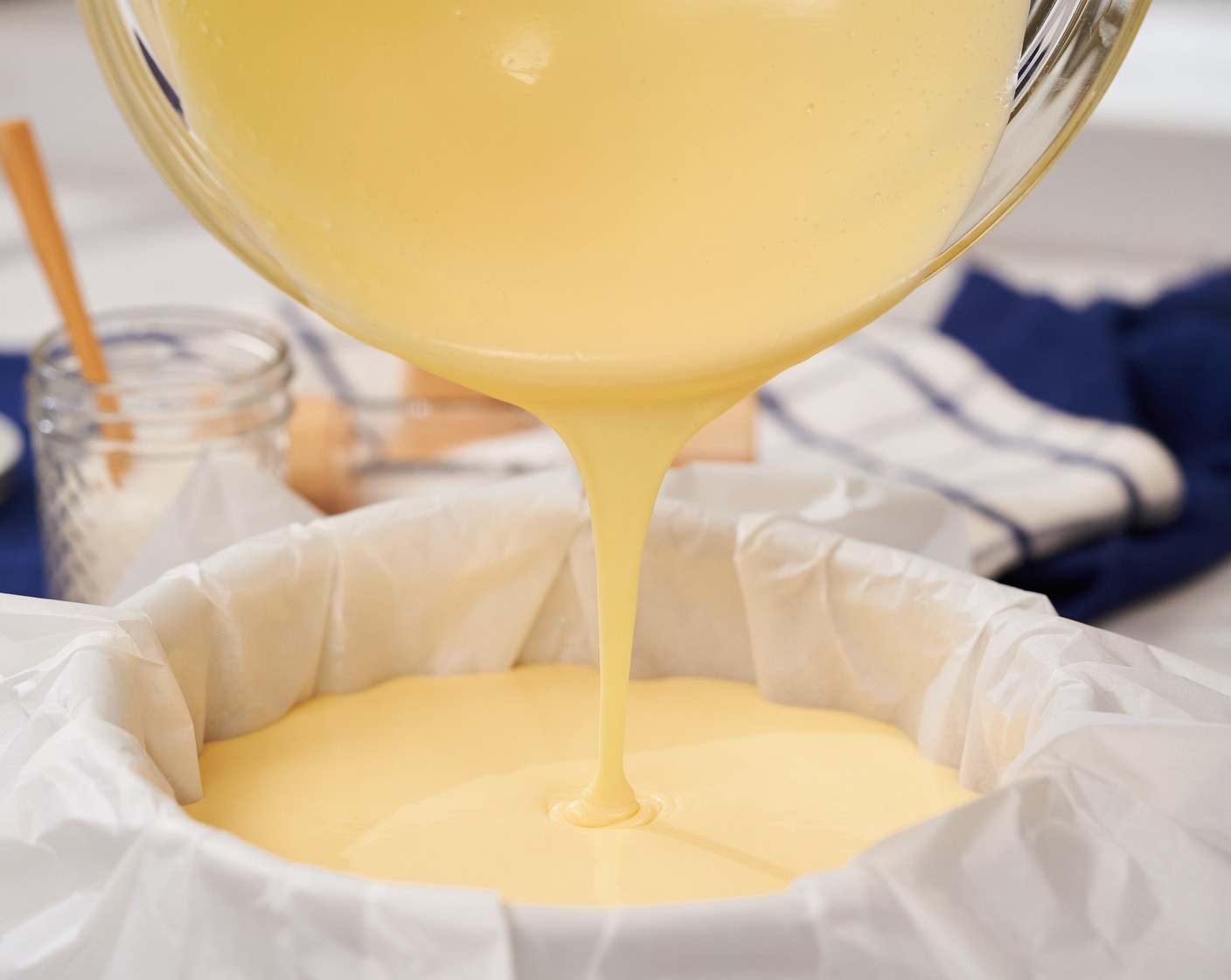 step 4 Use a fine mesh strainer to strain the mixture into a medium bowl. Then pour into the lined cake tin.