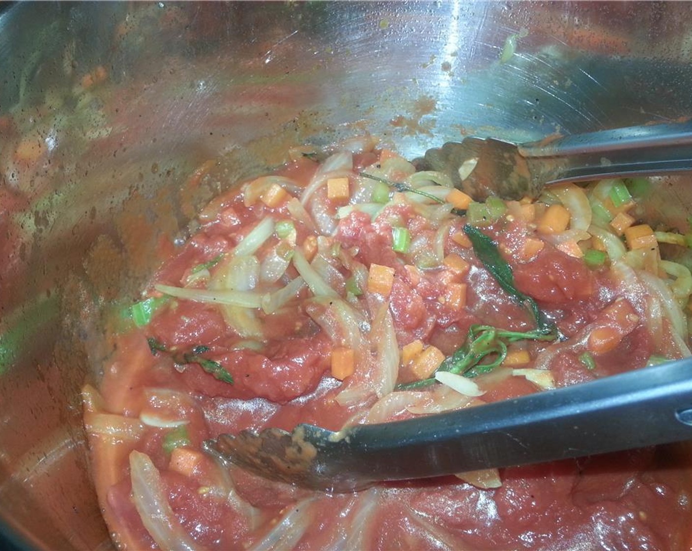 step 6 Once fragrant, add the Canned Whole Peeled Tomatoes (6 2/3 cups) and Chicken Stock (29 fl oz). Crush the tomatoes using a pair of tongs. Season again with a bit more Salt (to taste) and Ground Black Pepper (to taste).