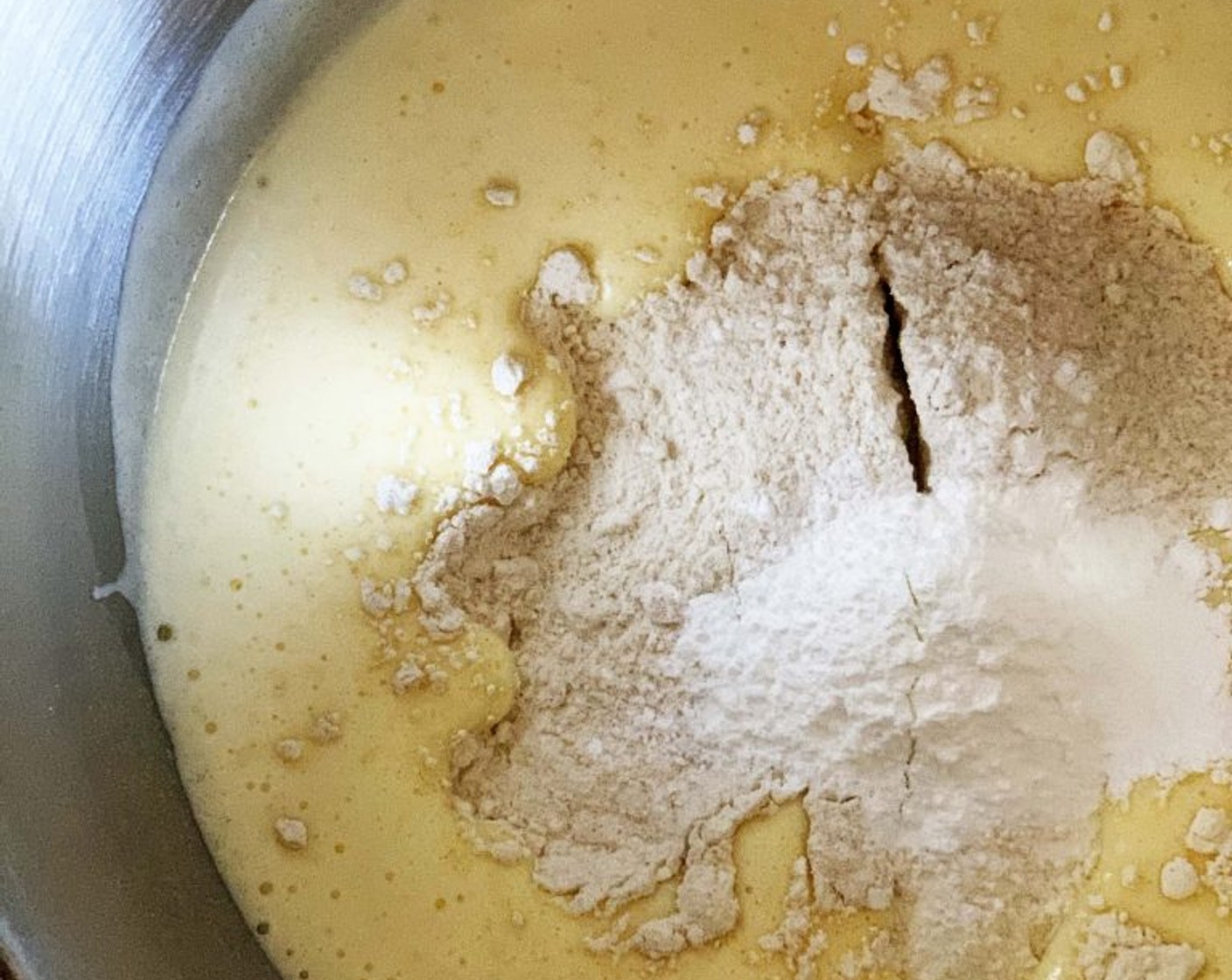 step 3 Add in the Lemon Marmalade (1/2 cup), Ghee (3 2/3 Tbsp), and Water (1/3 cup), slowly whisk those in. Next, add in the Cake Flour (1 cup), Type 2 Flour (1/3 cup), Salt (1 pinch), and Baking Powder (0.5 oz) gently folding them into the batter with a spatula.