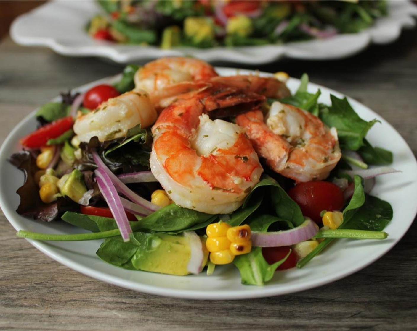 step 10 Just before serving, add the reserved dressing and toss to coat. Top with grilled shrimp and get after it.