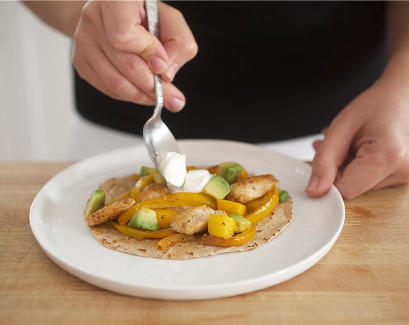 step 11 Place 2 tortillas on each plate. Spoon the fajita mixture onto the tortillas and top with avocado and Sour Cream (1 pckg).