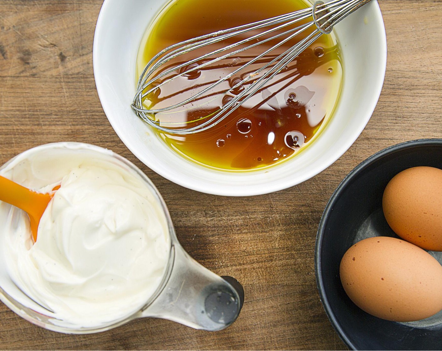 step 7 In another mixing bowl, combine Coconut Oil (1/2 cup) and Maple Syrup (1/2 cup) and beat together with a whisk. Add Eggs (2), Greek Yogurt (1 cup) and Vanilla Extract (1 tsp) and continue to beat together.