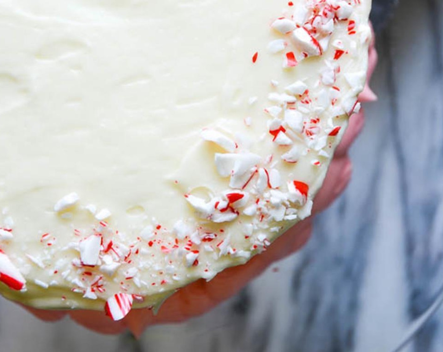 step 16 Switch the round tip to a star tip and pipe any remaining frosting around the base of the cake. Sprinkle Hard Peppermint Candies (to taste) around the rim.