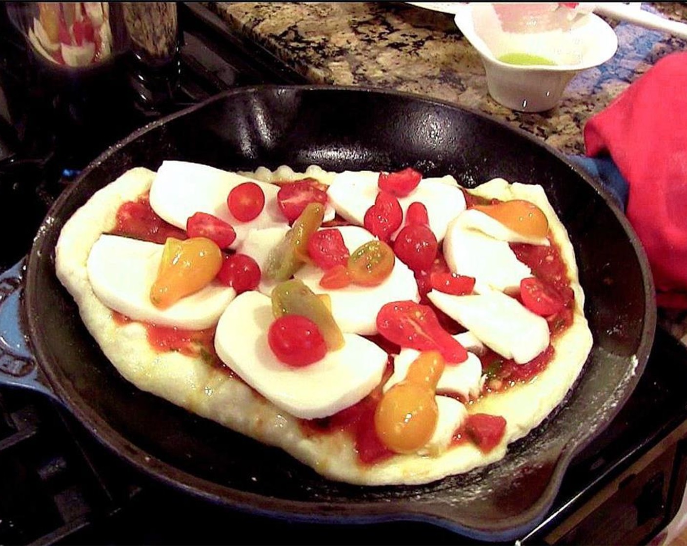 step 13 Layer on half of the sliced mozzarella and grated Parmesan. Top with half of the sliced cherry tomatoes.