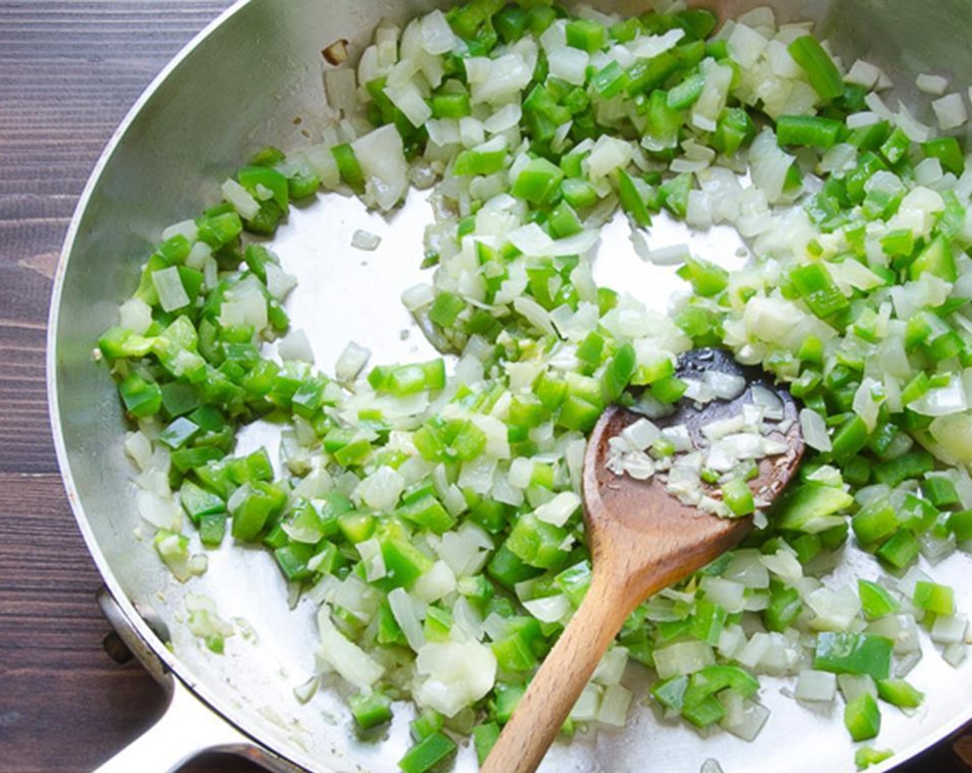 step 6 Chop the Onion (1) and Green Bell Pepper (1). Mince the Garlic (3 cloves). Heat a large skillet over medium high heat. Add the Olive Oil (3 Tbsp), onion, bell pepper and garlic and sauté for 4 to 5 minutes until the vegetables soften.