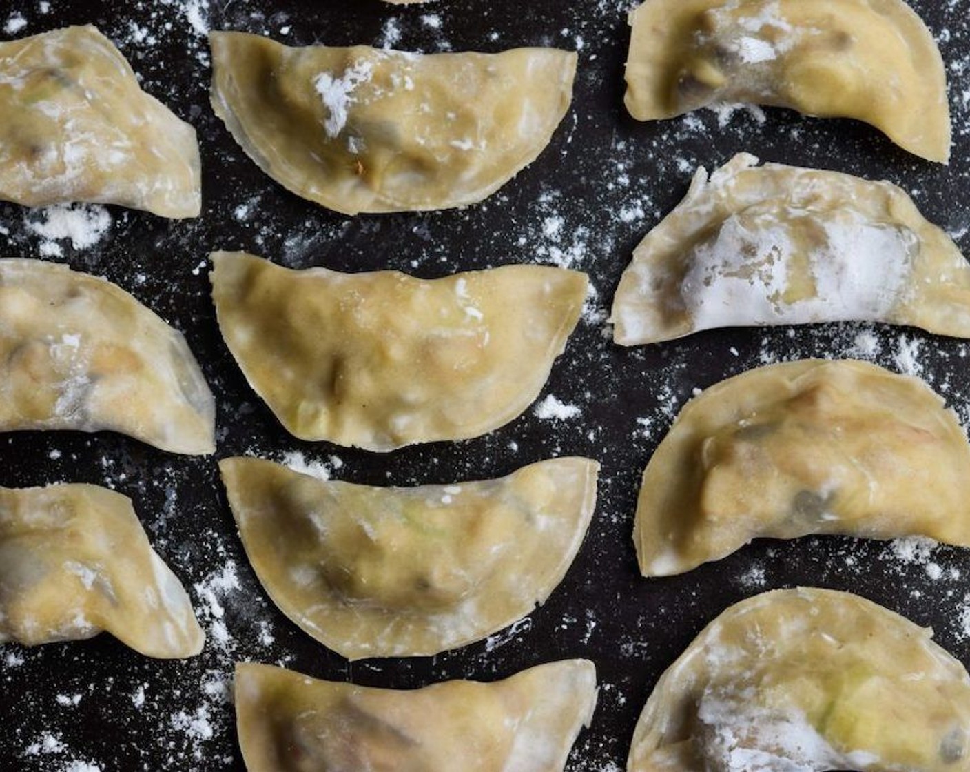 step 4 Keep a small bowl of water handy to seal the dumplings, using a finger to wet the edges of the wonton wrapper, folding it in half and sealing in the filling by crimping the edges tightly. Set the dumplings on to a lightly floured surface until needed.