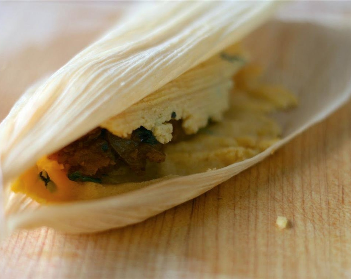 step 9 Carefully roll one side, allowing part of the dough to peel off and meet the other side.