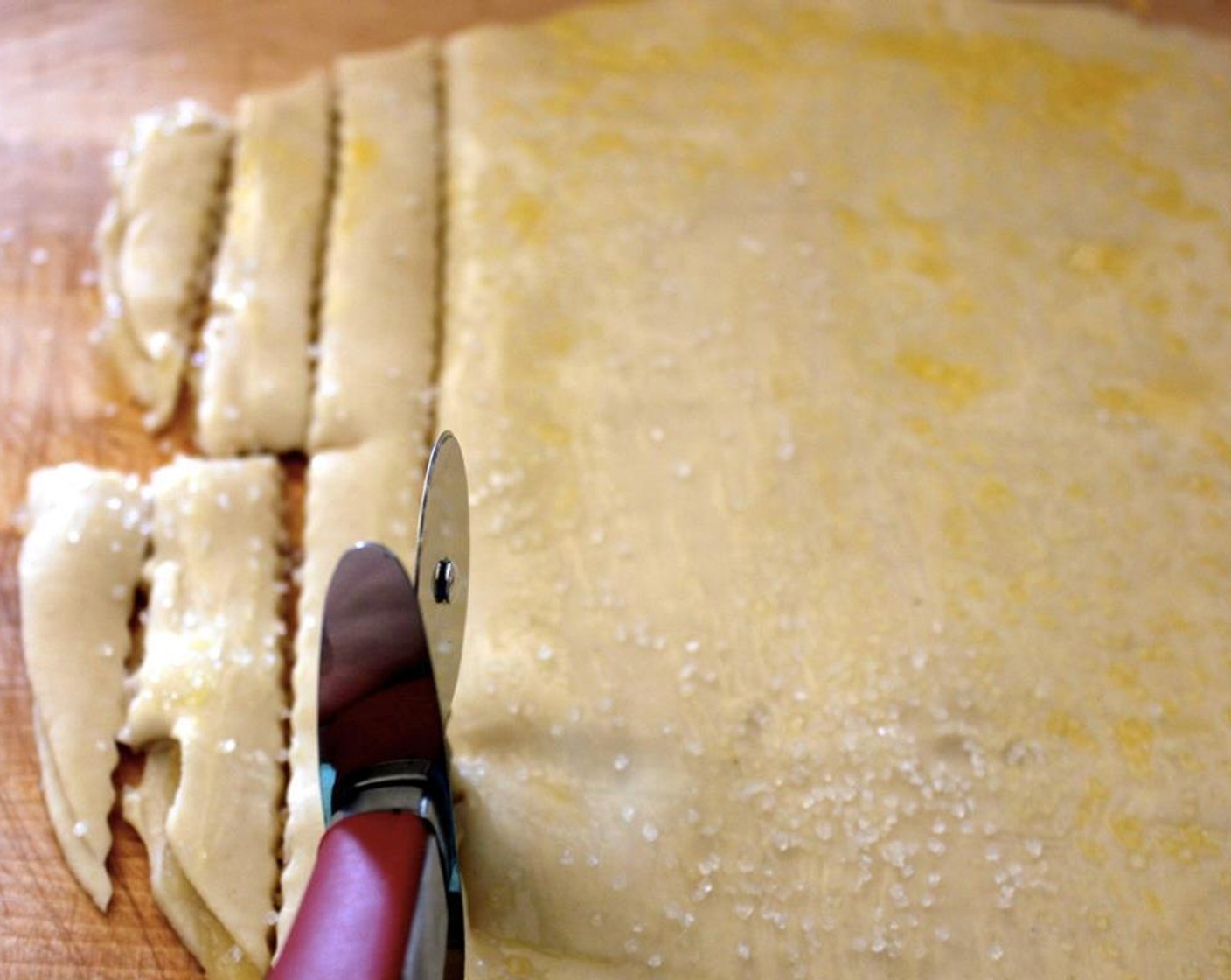 step 5 Brush some egg wash on top of the crust and sprinkle the Sparkling Sugar (to taste) to mimic the look of salty fries. Cut strips about 1/2-inch thick and cut those into fry shapes.