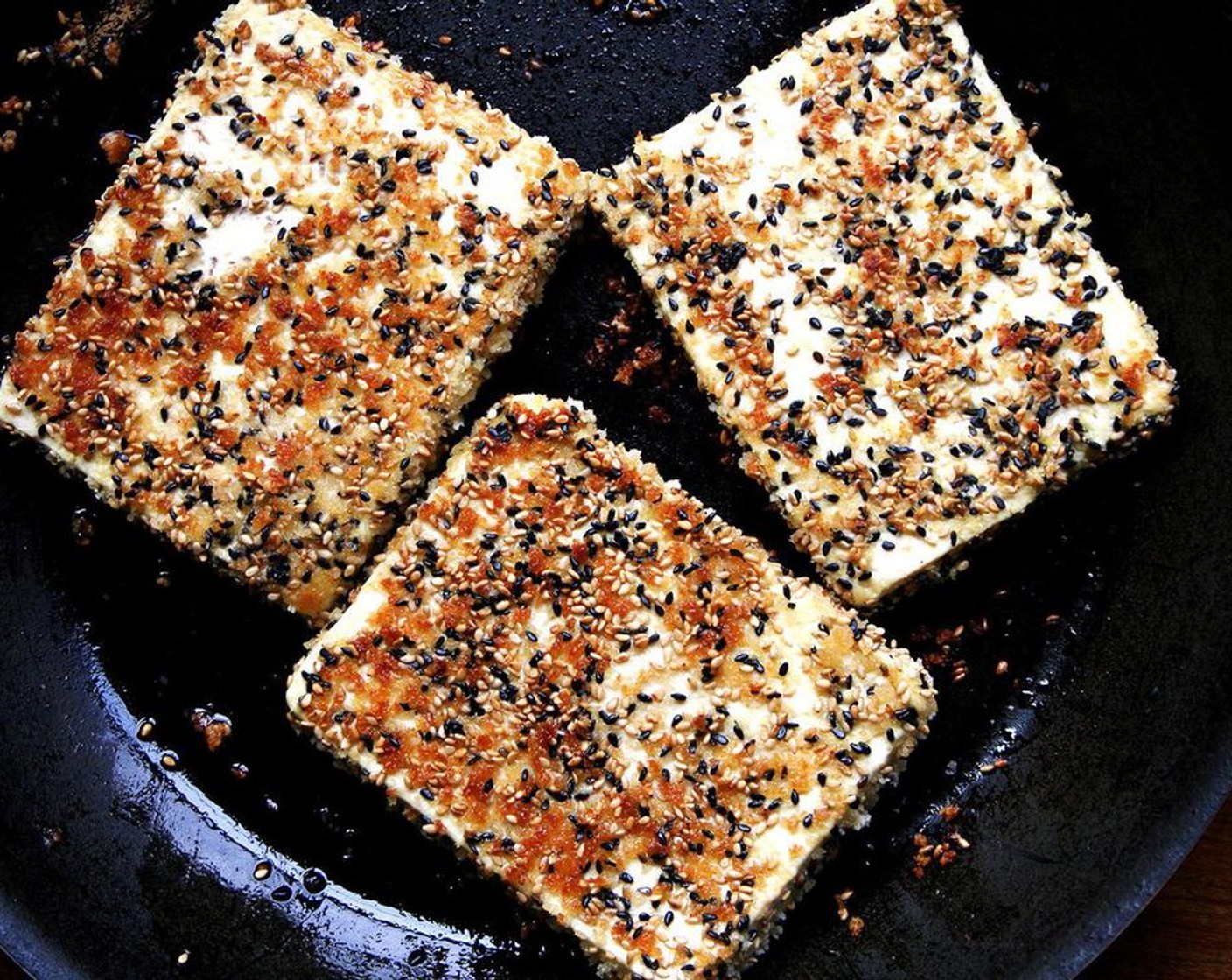 step 6 Heat a large nonstick frying pan over medium-high heat. When it’s hot, add Canola Oil (as needed). Carefully lay each piece of tofu into the frying pan. Turn the heat down to medium if the slices appear to be browning too quickly. Crisp tofu slices for about 3-4 minutes a side, then transfer to a serving platter.