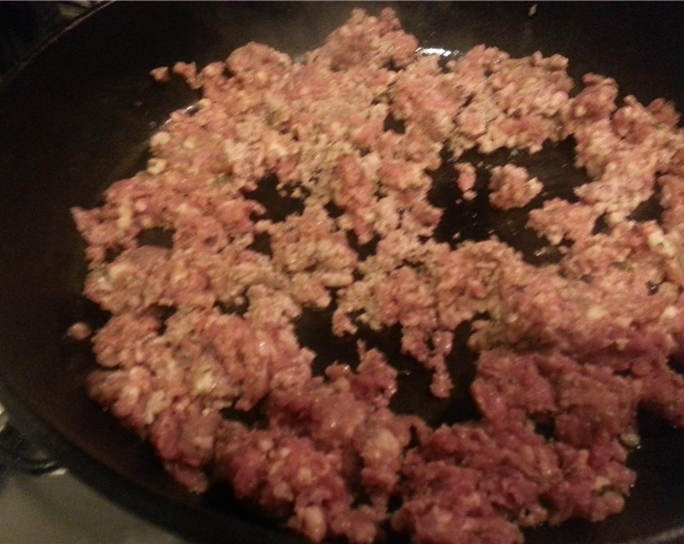 step 2 In a large cast iron pan over medium heat, melt the Unsalted Butter (2 Tbsp) and begin browning the Country Style Sausage (1 lb). Use a wooden spoon to break the sausage up into smaller pieces.