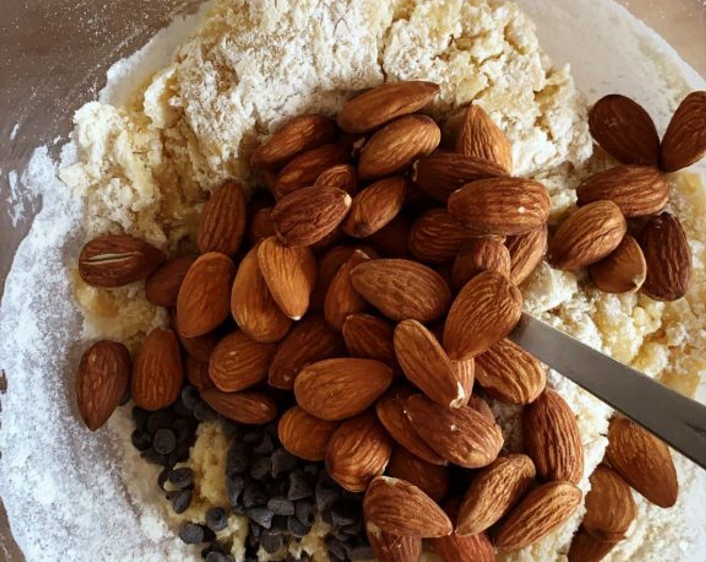 step 2 In a bowl whisk together Vegetable Oil (2.5 oz), Granulated Sugar (2/3 cup), and Egg (1). Add the Cake Flour (1 cup), Corn Starch (1/2 cup), Salt (1 pinch), Baking Powder (1 tsp), and give it a stir. Then add the Almonds (2/3 cup) and Dark Chocolate Chips (1/2 cup), if using.