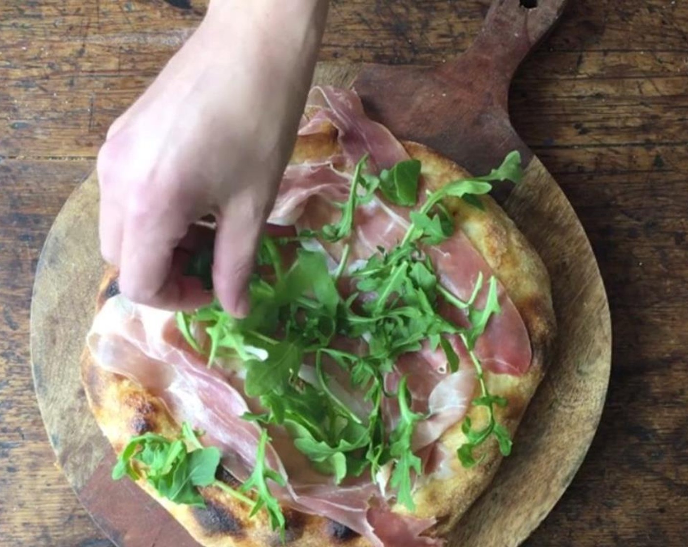 step 9 Remove from oven. Top with Prosciutto (to taste), Arugula (to taste), and drizzle with additional Extra-Virgin Olive Oil (to taste). Sprinkle with Sea Salt (to taste).