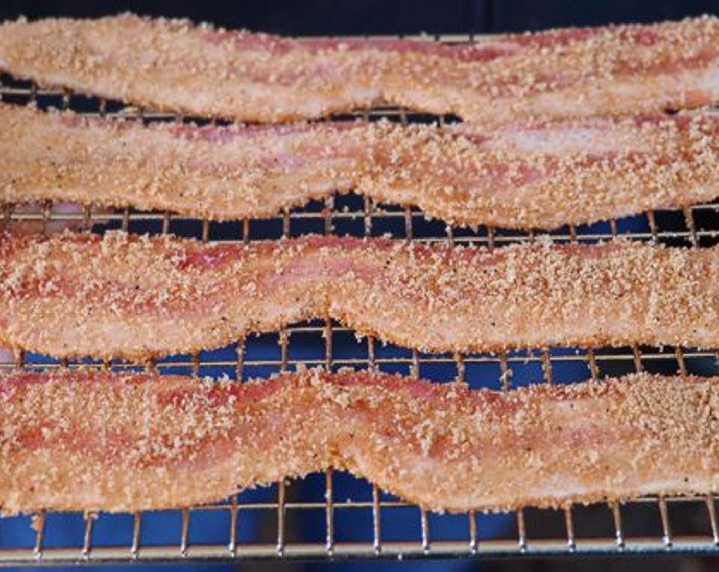 step 5 Combine Brown Sugar (1 cup) and Cajun Seasoning (1 Tbsp) in a small bowl. Cover the Thick-Cut Bacon (8 slices) with the sugar mixture and place on a cooking rack (spray the rack with cooking spray to prevent sticking).