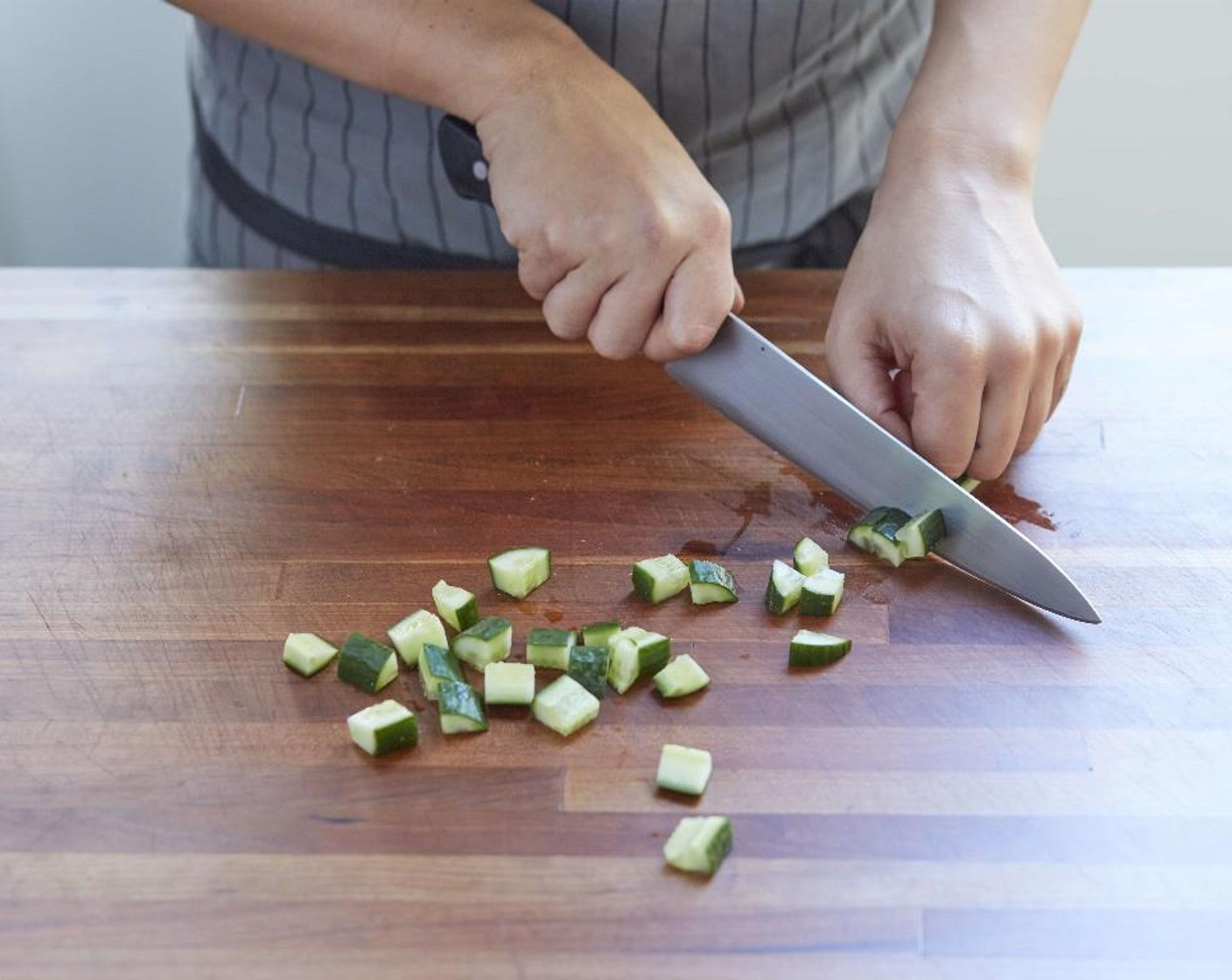 step 5 Cut the Mini Cucumber (1) in half lengthwise and then into 1/4 inch dice and place in a medium bowl.