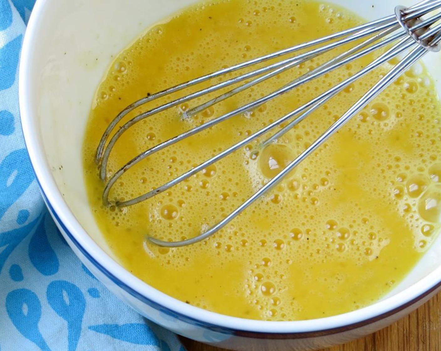 step 5 In a small bowl, whisk the Eggs (2). Add the Water (1 Tbsp), Kosher Salt (1/4 tsp) and Ground Black Pepper (to taste). Whisk again until light and fluffy.