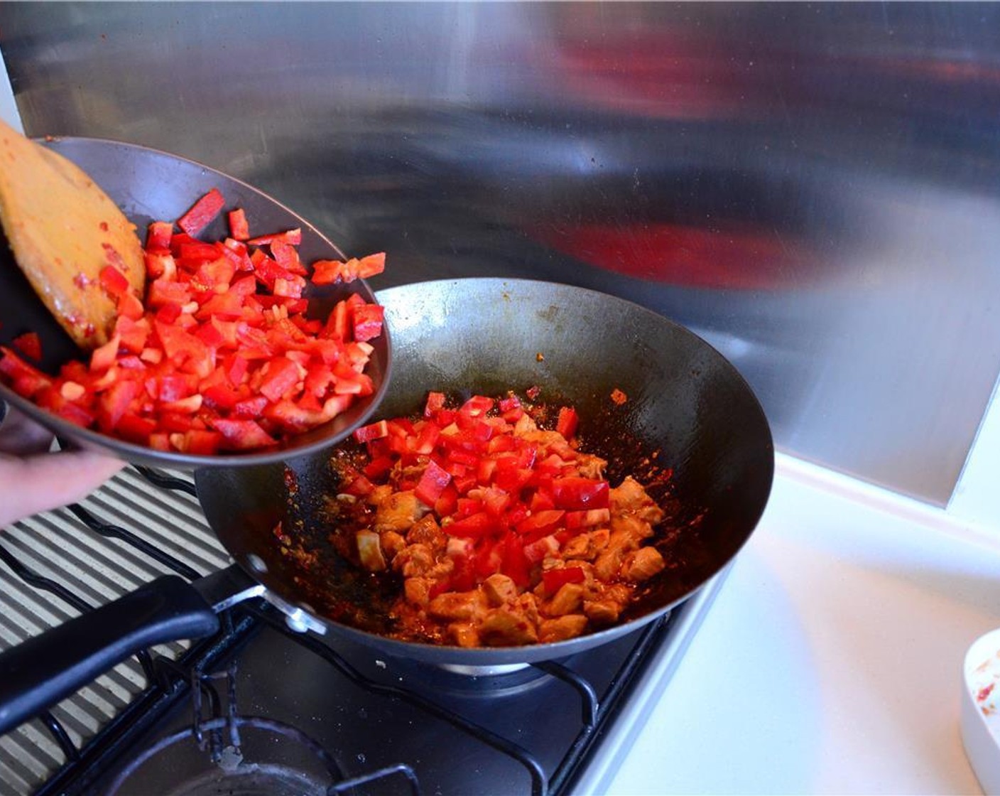 step 6 Add the red bell pepper and stir fry until soft.
