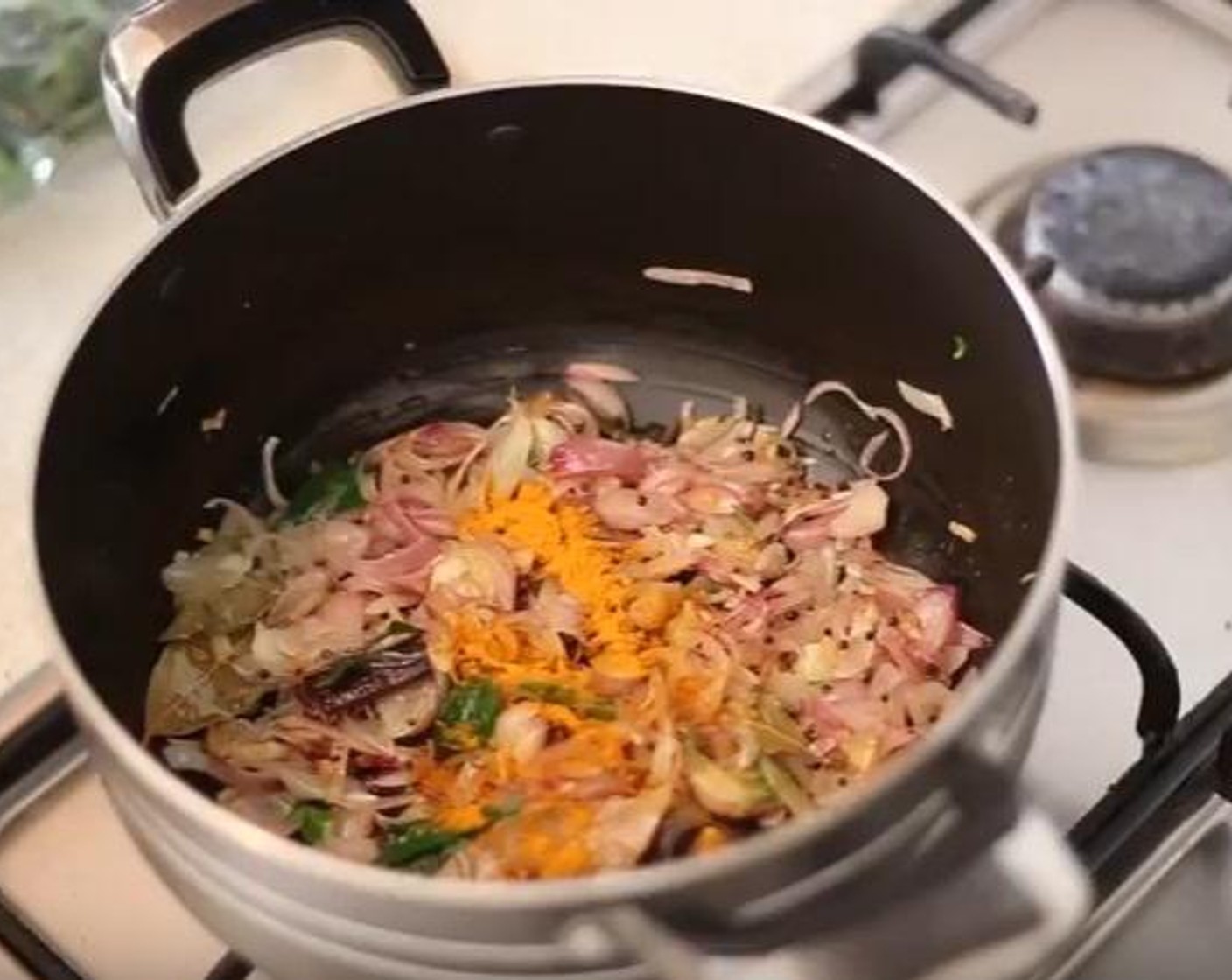 step 6 After a while, add the Shallot (2/3 cup), spring Curry Leaf (1), Ground Turmeric (1 tsp) to the cooking bowl, and saute for 2 minutes under low heat.