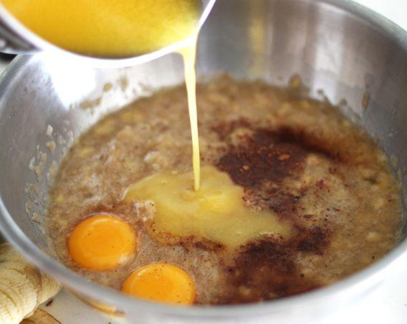 step 4 Mix mashed bananas, melted butter, yolks of the Eggland's Best Classic Eggs (2), Vanilla Extract (1 tsp), Brandy (1 1/2 Tbsp), Baking Soda (1 tsp), Salt (1 pinch), Simply Organic Cinnamon, Ground (2 tsp), and Ground Nutmeg (1/2 tsp).