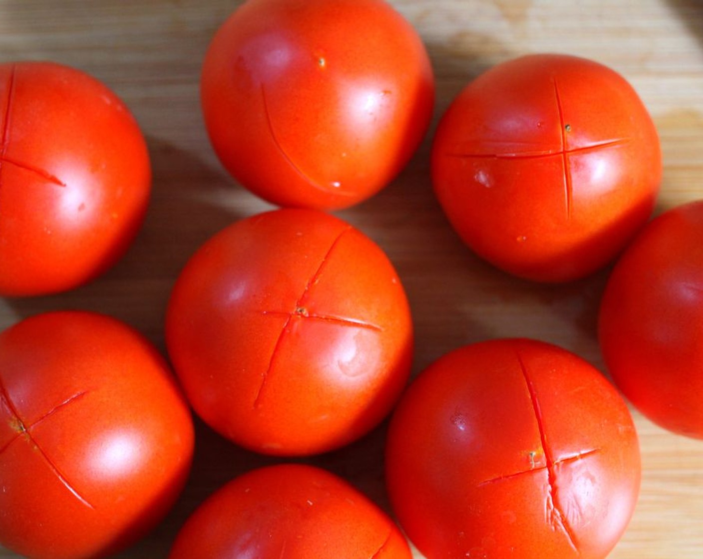 step 1 Wash the Tomatoes (8) and use a knife to cut an "X" on the bottom of each.