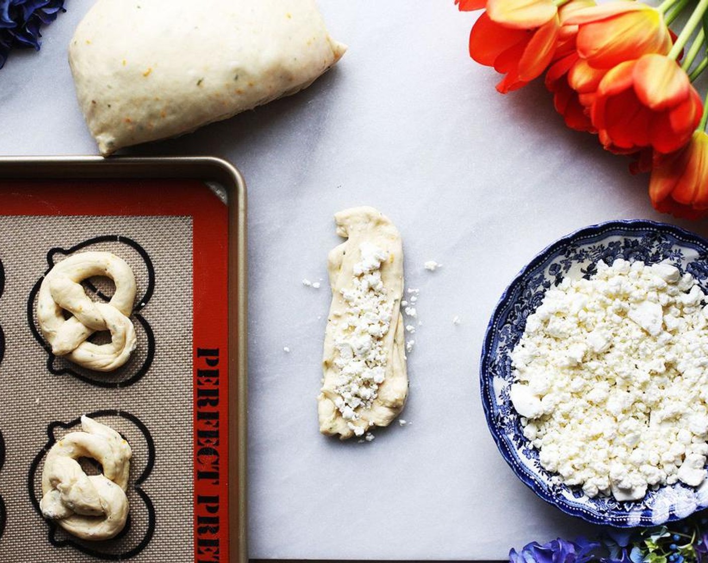 step 7 Divide the Goat Cheese (2 cups) evenly down the center of each portion of dough. Take the dough from the long ends and wrap around the cheese. Pinch the dough together and fold under all along the entire edge until the goat cheese has been hidden.