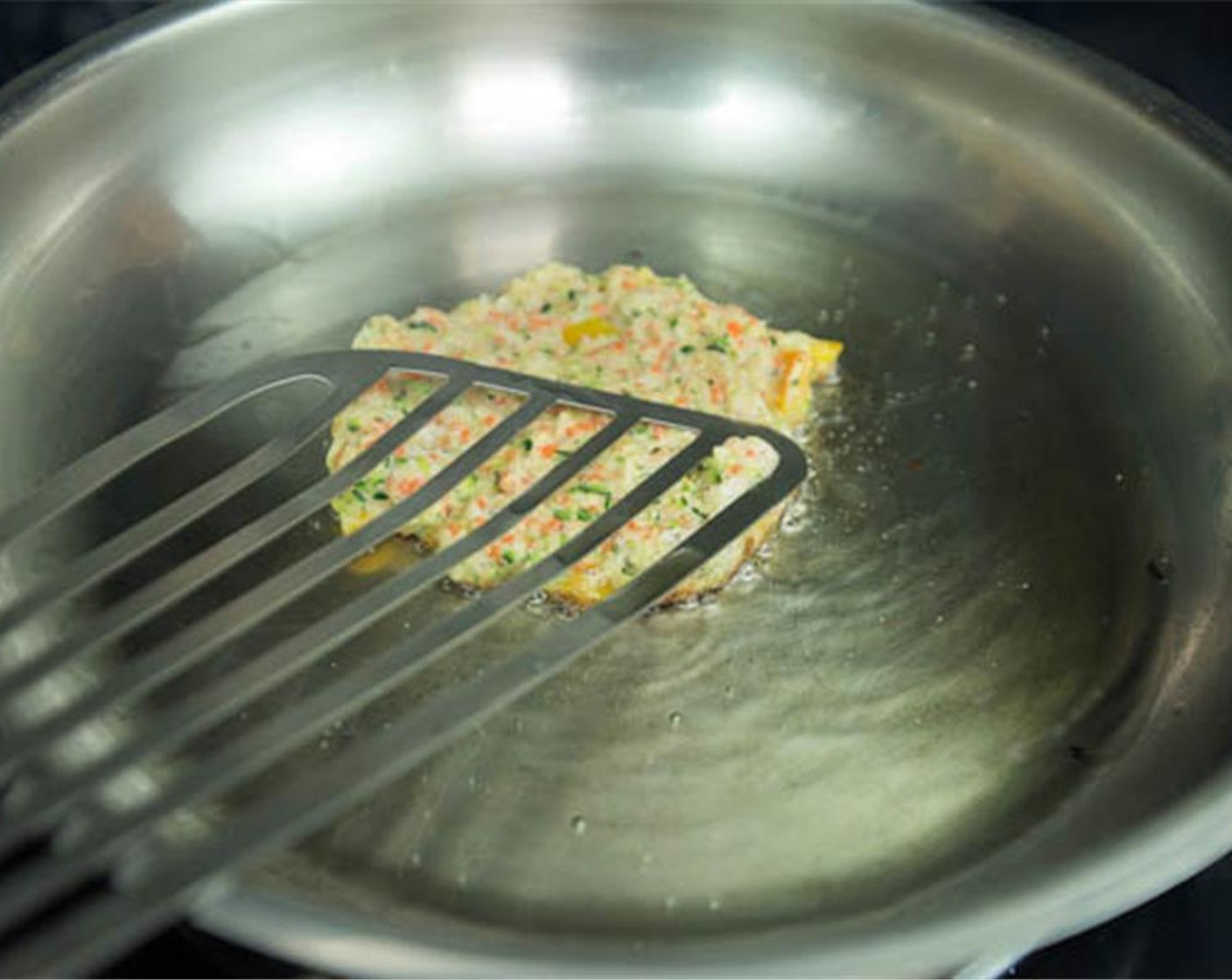 step 7 In a heated skillet with Olive Oil (as needed) spoon a quarter cup of the mixture into the pan and flatten with a spoon. Cook until golden brown.