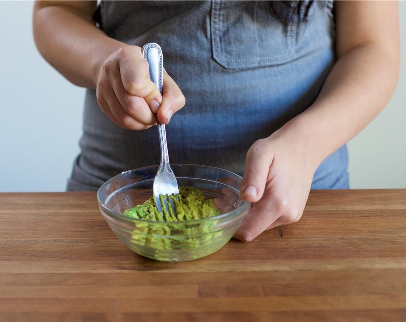 step 4 Cut the Avocado (1) in half, remove the skin and pit. Scoop the flesh out of the avocado and place into a small bowl. Using a fork, smash the avocado and add Salt (1/4 tsp) and Ground Black Pepper (1/4 tsp). Mix until well combined and set aside.