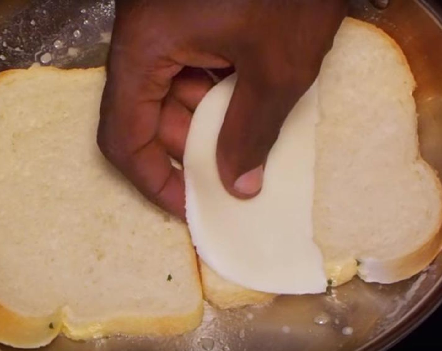 step 6 Brush the butter over one side of the Sandwich Bread (to taste). Put the breads in the pan and cook on medium heat. Place Cheese (to taste), Tomatoes (to taste) and Fresh Basil (to taste) on top of the breads. Lay some more cheese on top. Spread more butter on the top of more bread, and place them on top. Flip the sandwiches every minute and brown them for four total minutes or until the cheese has melted.