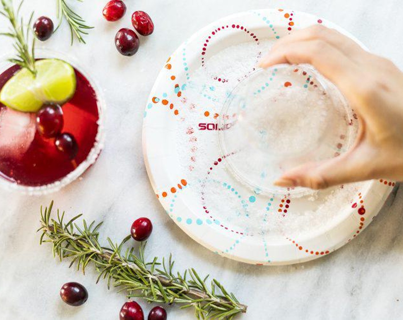 step 3 Moisten the rim of a 9-ounce clear cup with a Lime Wedge and dip in Solo AnyDay Paper Plate filled with Salt (to taste).