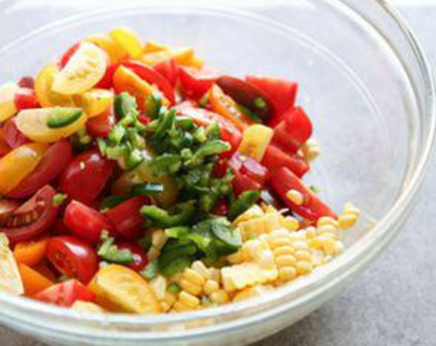 step 2 In a large mixing bowl, combine the Cherry Tomatoes (2 cups), Corn Kernels (1 1/4 cups), Jalapeño Pepper (1), and Shallot (1).