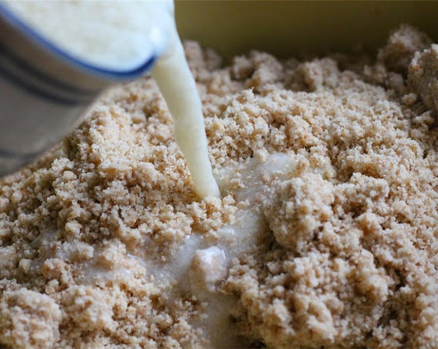 step 5 Add the milk mixture, along with the Sour Cream (1/2 cup). Stir until dough clings together. If your flour mixture is still a little dry and crumbly, you may add a little more cold water until it all clings together nicely.