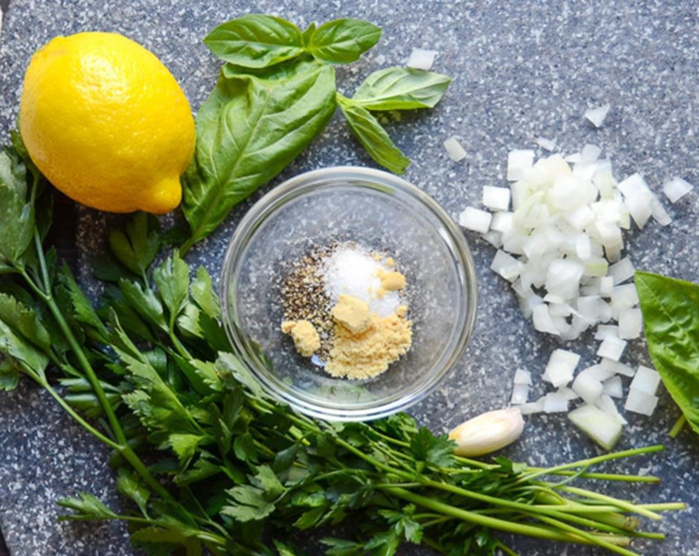 step 2 Gather the ingredients for the dressing. Chop the Fresh Parsley (2 Tbsp). Chop the White Onions (2 Tbsp) and Fresh Basil Leaves (5). Peel and chop the Garlic (1 clove).