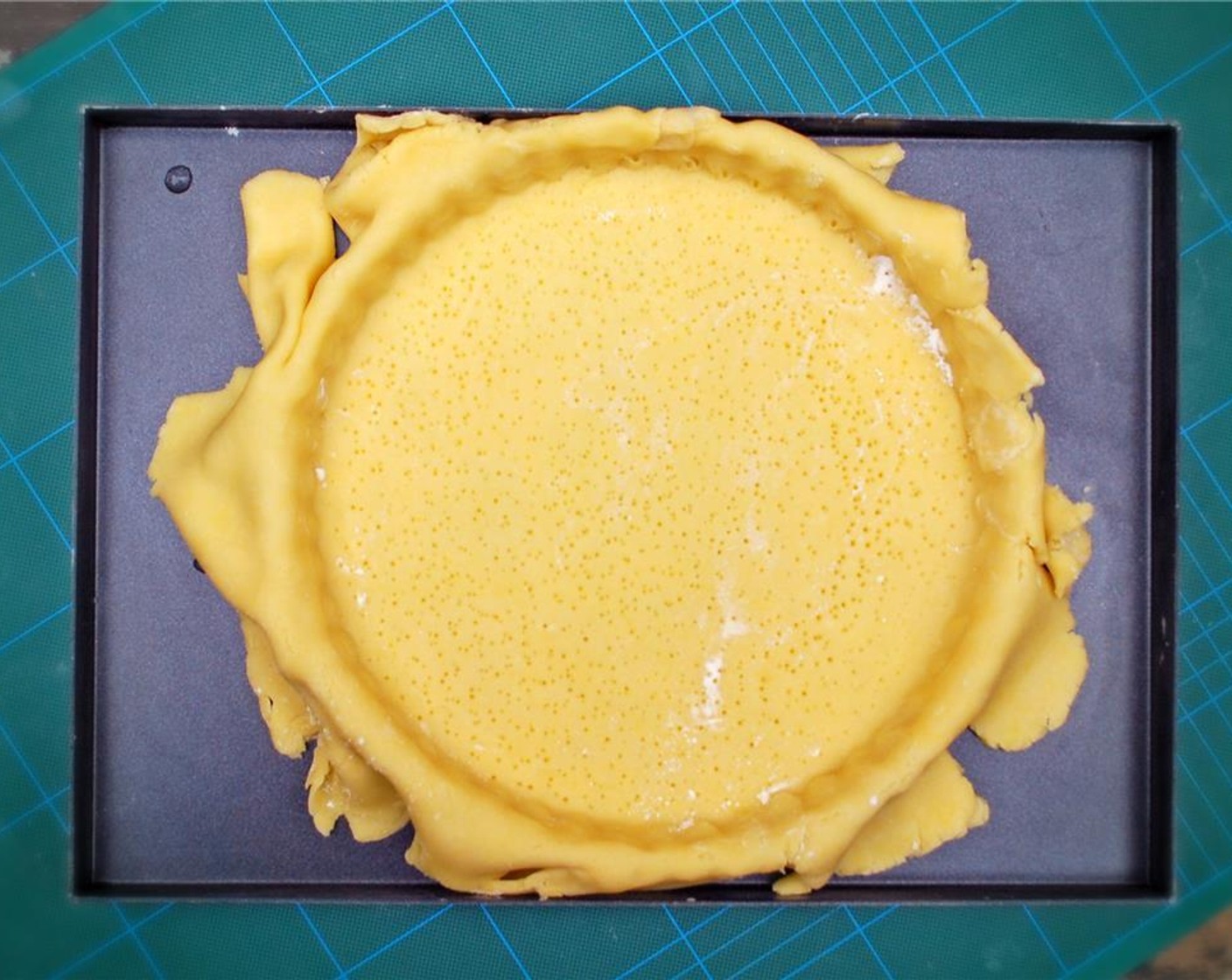 step 7 Use the rolled pastry to line a 25 cm (9-in) easy release tart case, pressing the dough gently into the sides with your fingers whilst being careful not to stretch the pastry.
