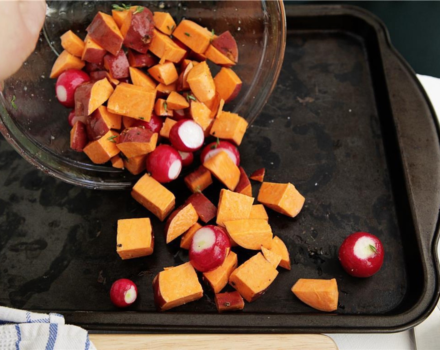 step 5 Carefully spread the seasoned veggies evenly on the preheated baking pan, and cook for 15-20 minutes, or until tender and golden brown.