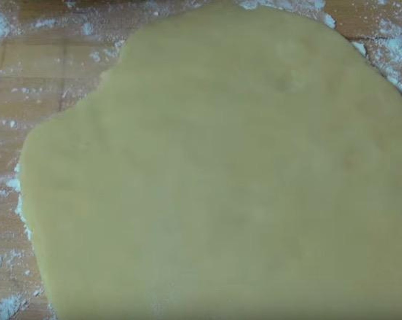 step 4 Using a rolling pin, gently roll the dough out on a floured surface, until it is about 1 centimeter thick.