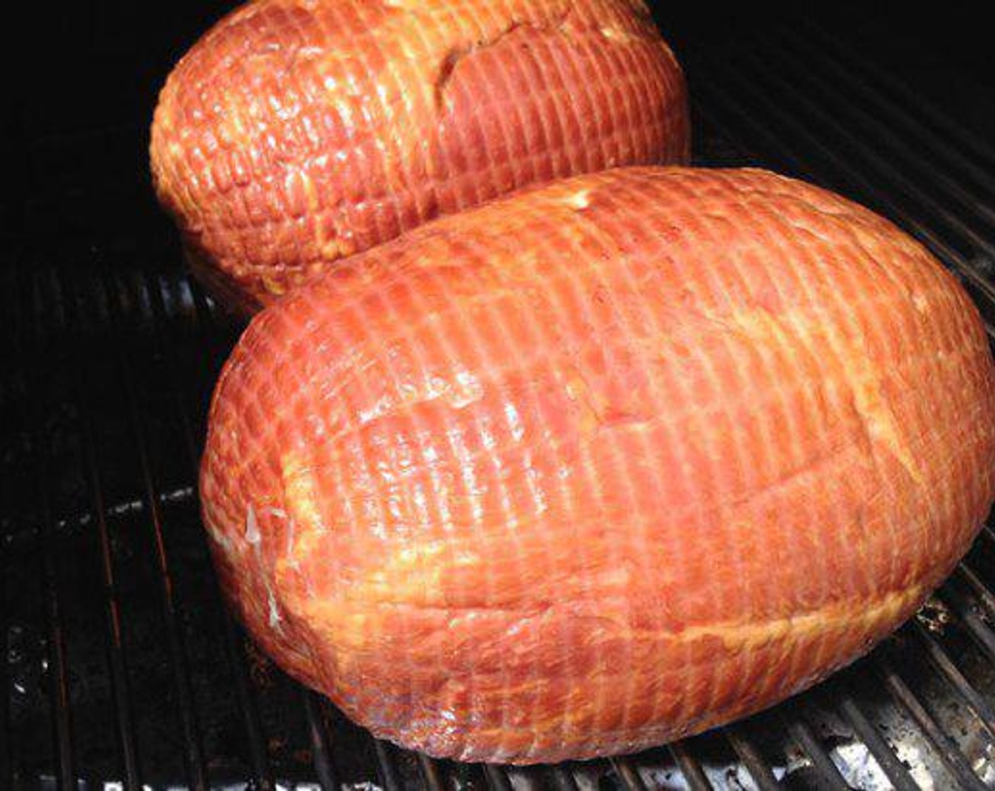 step 1 Setup smoker or grill for indirect heat and set it to hold a steady 275 degrees F (140 degrees C). Remove the Cooked Pit Ham (8 lb) from the packaging and place it on the smoker.