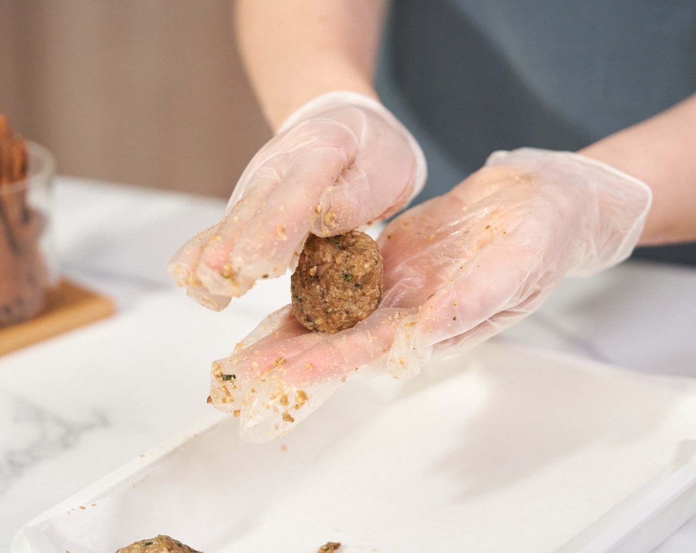 step 7 Shape the meatballs into ping pong size balls. Set aside on a parchment-lined tray.
