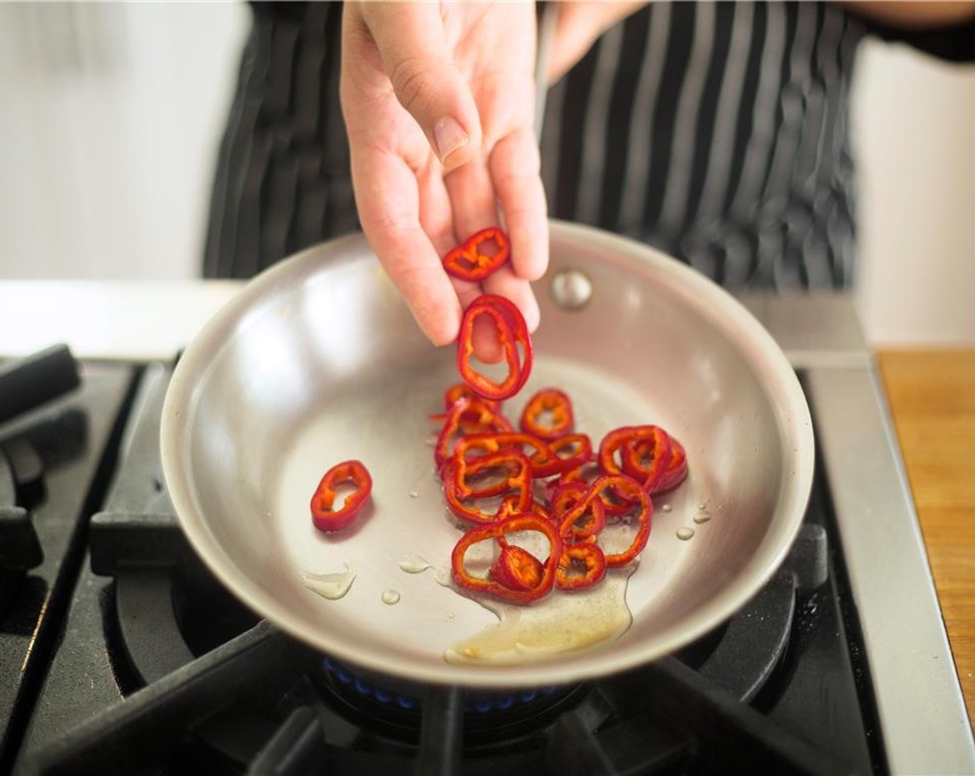 step 8 Remove from heat, add sliced chilies to sugar-vinegar mixture, stir and remove chilies and any liquid from the pan to cool. Rinse and dry pan.