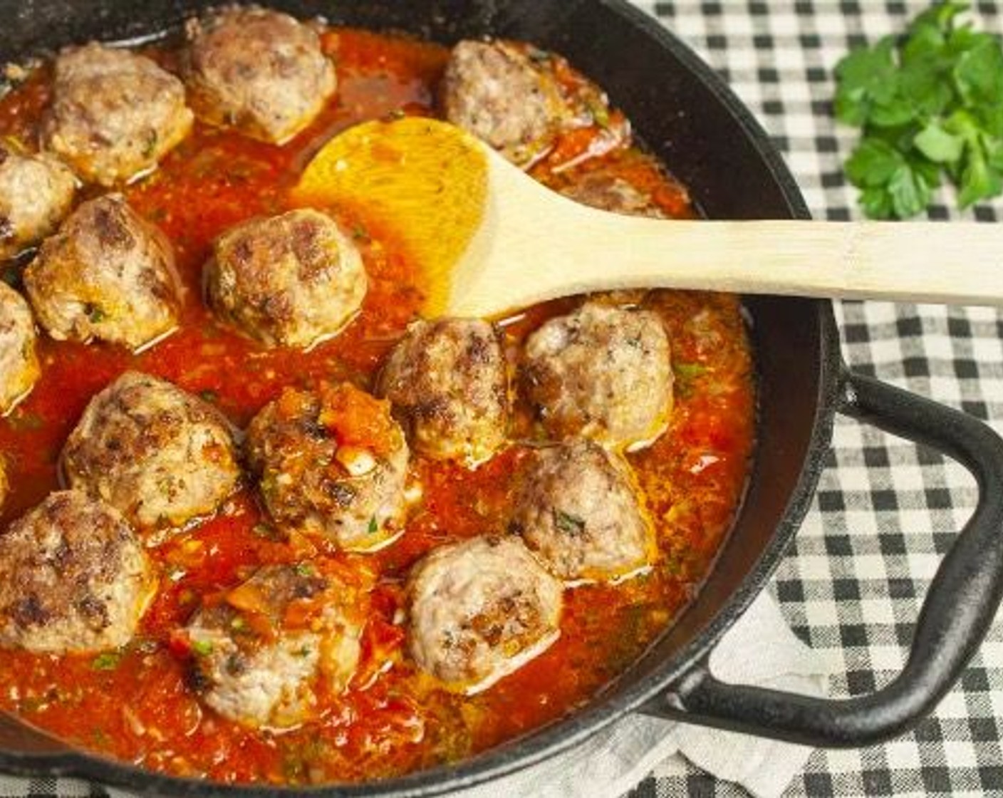 step 7 Using your hands, crush Canned Diced Tomatoes (1 1/2 cups) and add to skillet along with Fresh Oregano (1 Tbsp),  Paprika (3/4 tsp), and Ground Black Pepper (1/4 tsp), Stir to combine and bring to a simmer. Add meatballs back to pan, stirring to coat with sauce.